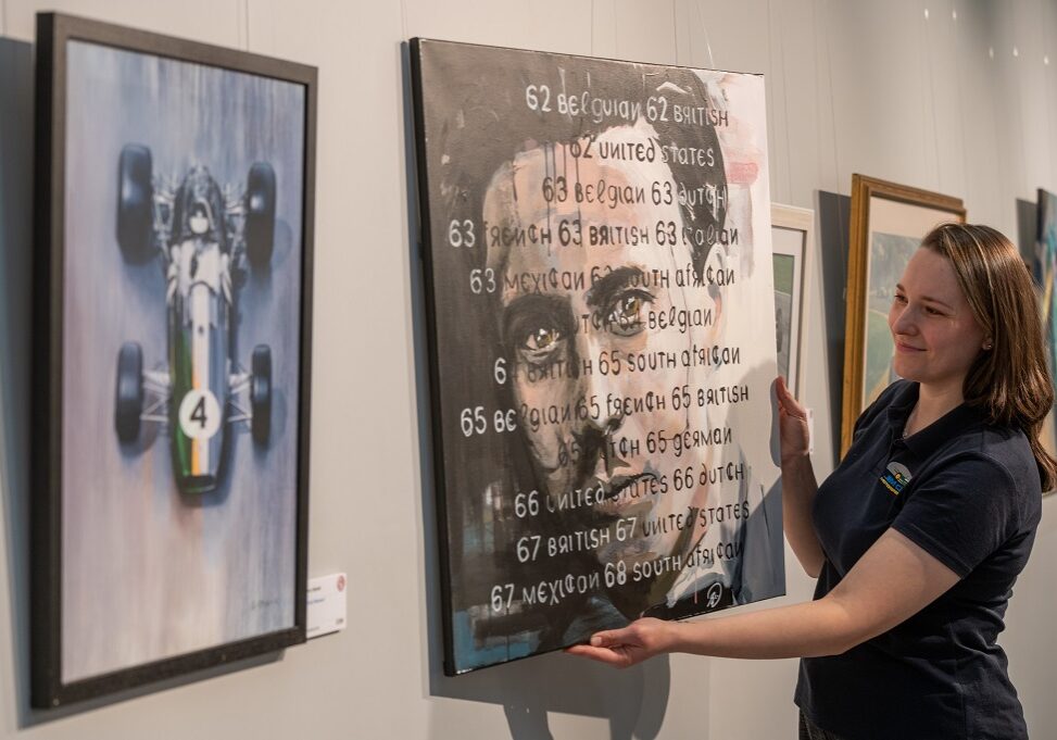 Yulia Tarasenko, pictured hanging one of the paintings called, Face of a champion, by Sean Wales (Photo: Phil Wilkinson)