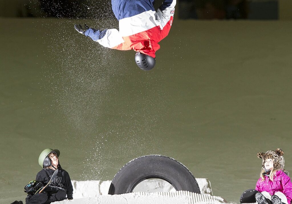 Kids enjoy the snow as former World Cup snowboarder Ben Kilner somersaults at Snow Factor (Photo: Jeff Holmes)