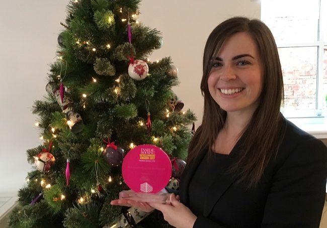 Laura Burns, sales consultant, with the award
