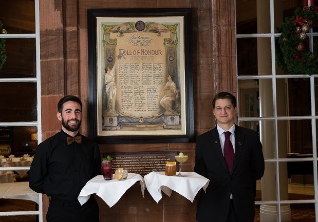 Waldorf Astoria staff in Edinburgh in front of the restored Roll of Honour, with cocktails which will raise funds for veterans' charities