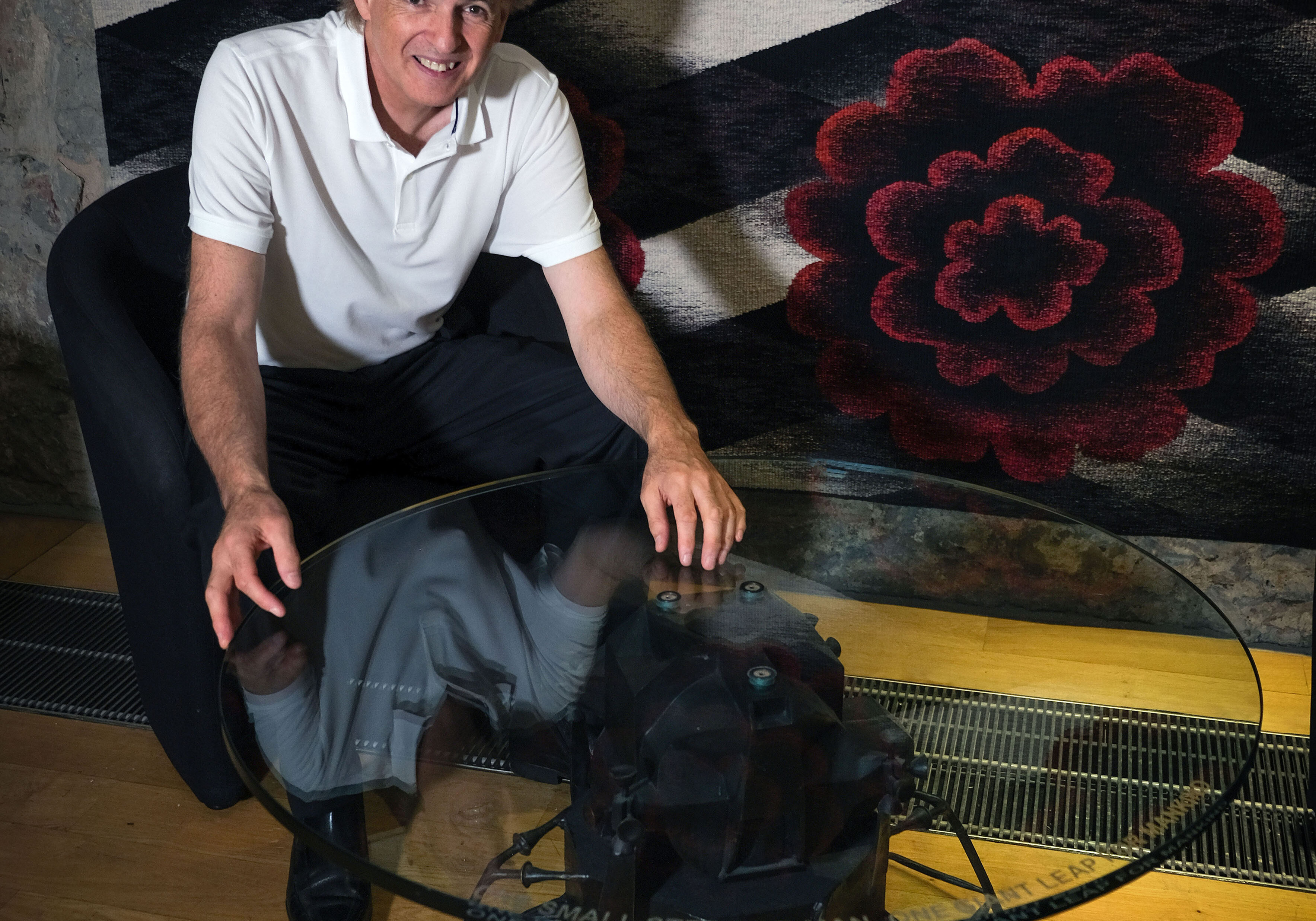 Artist and designer Mark Stoddart at Scottish Parliament with a one of his special tables