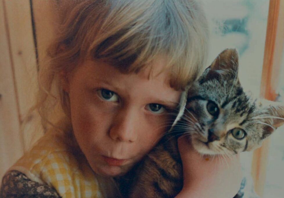 Phamie Gow aged five with the family cat Rousseau. [Photo: Phamie Gow]