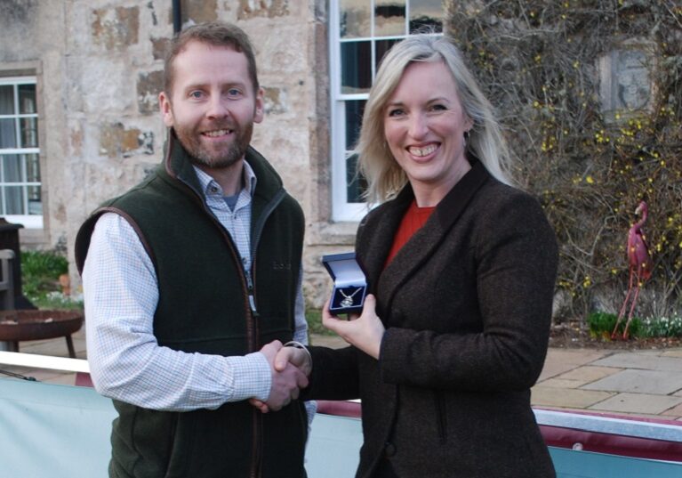 Tricia Schooling is presented with her prize by Jake Swindells from BASC