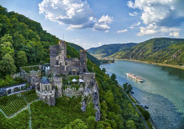 Viking longship on the Rhine River passing Rheinstein Castle, near the town of Trechtingshausen. [Viking]