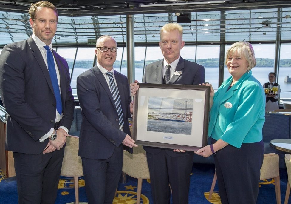 Captain Lars Kjeldsen, Master of Fred. Olsen Cruise Lines’ flagship Balmoral (second from right), presents Stuart Wallace, Chief Operating Officer of Forth Ports (second from left), with a special commemorative painting of Balmoral at a VIP Reception on board in the Port of Rosyth, along with Fred. Olsen’s Clare Ward, Director of Product and Customer Service, and Robert Mason, Capital Cruising’s Head of Cruise at Rosyth.  
(Photo: Peter Devlin)