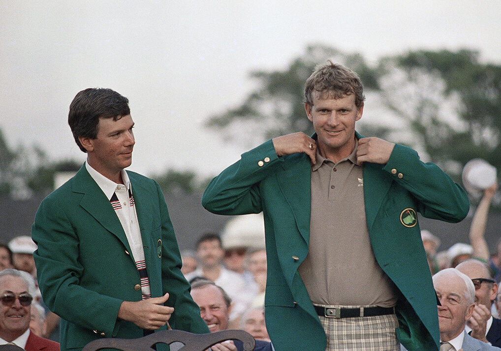 A smiling Sandy Lyle, right, is presented the Green Jacket of the Augusta National Golf Club after he won the 1988 Masters golf title