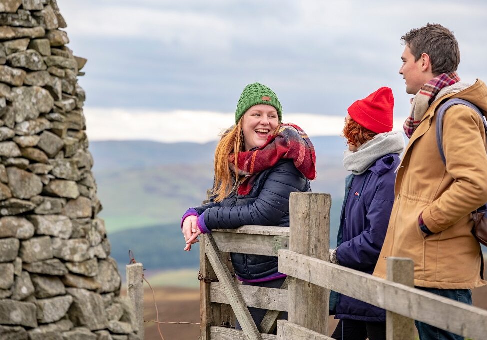 Three friends walk the route to The Three Brethren
cairns on the Southern Upland Way Scottish Borders