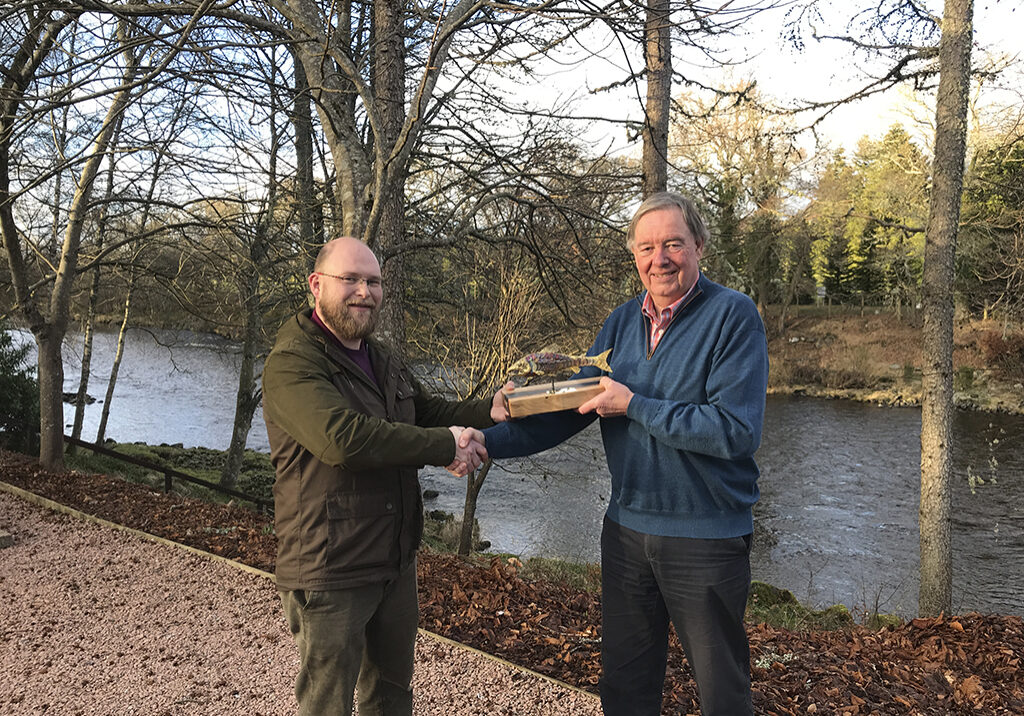 David Littlewood (left) of Banchory’s Tor Na Coille Hotel, presents the trophy to Lawrence Ross, chairman of the Dee Board